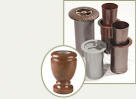 several different bronze cylindrical containers